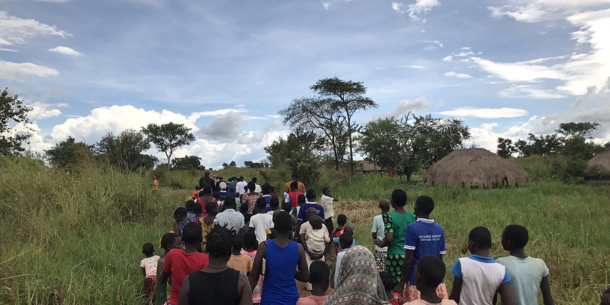 The people of the villages gather to walk to the new clean water well.
